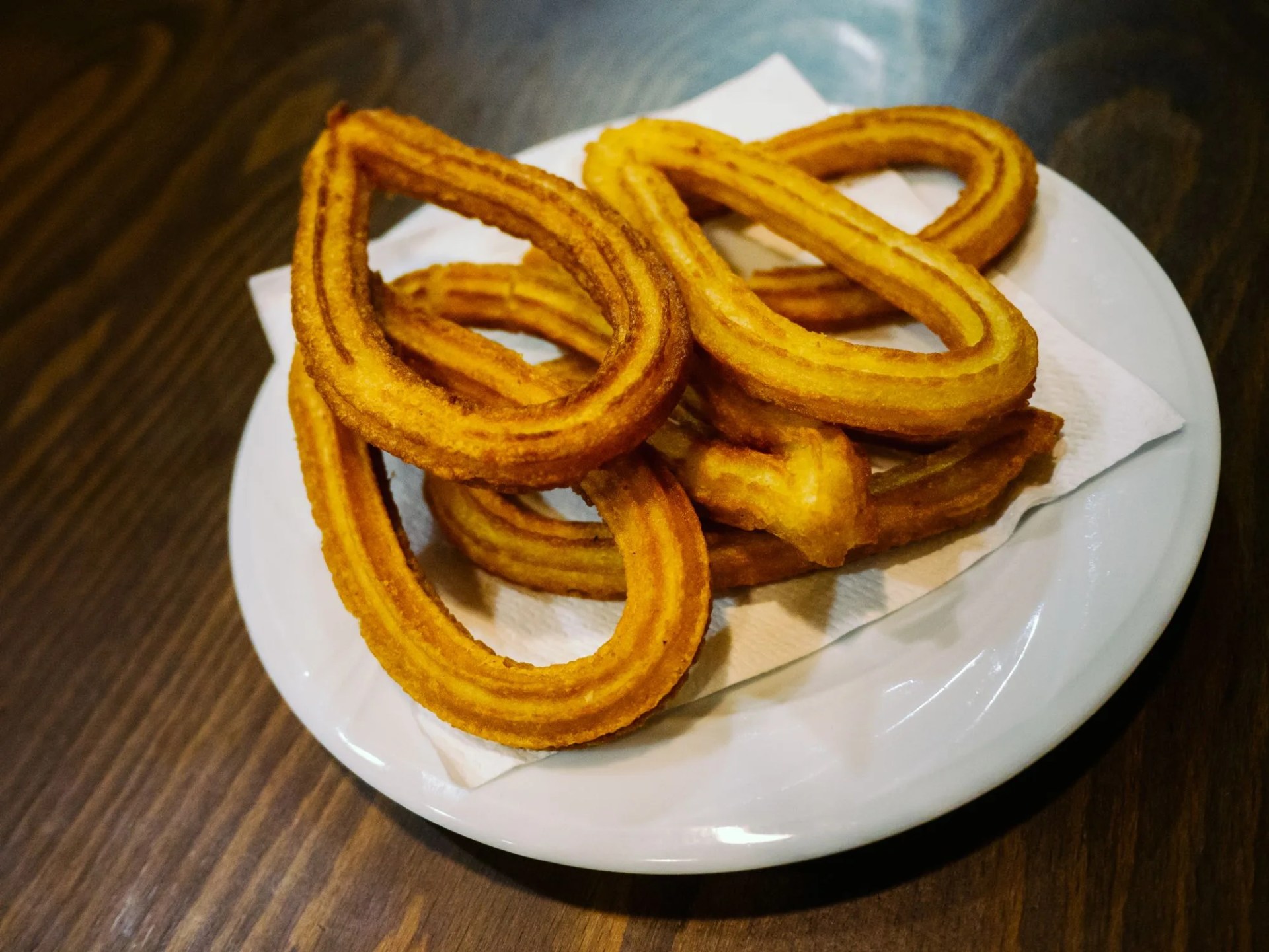 plate with churros on the table, ready to eat