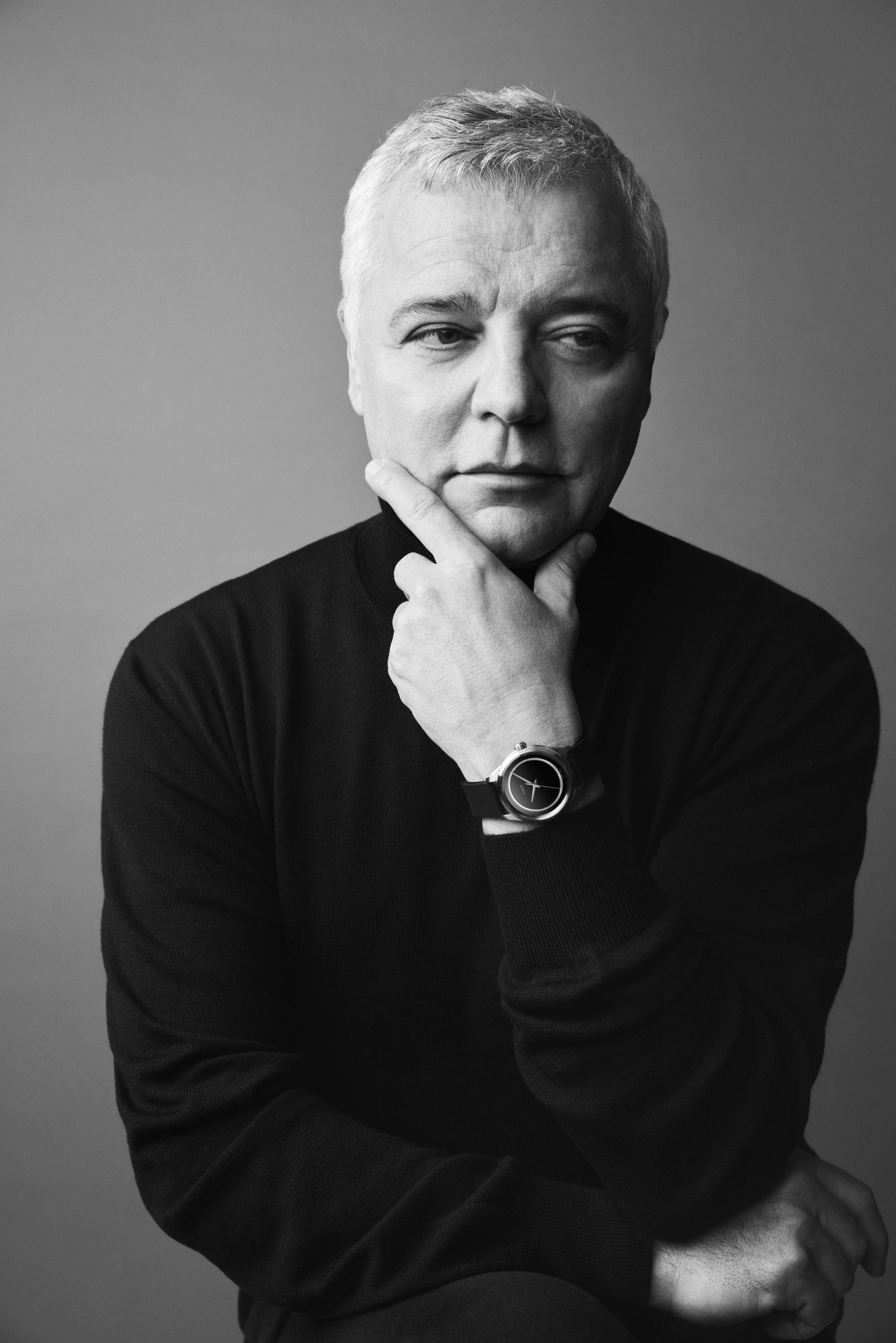 man wearing watch in black and white