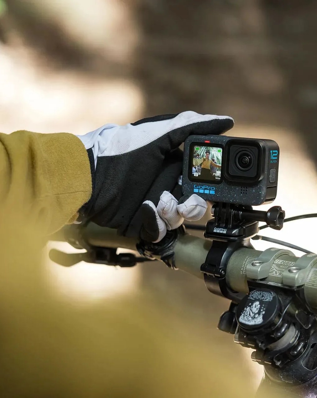 person riding bike with gopro hero12 black action camera attached