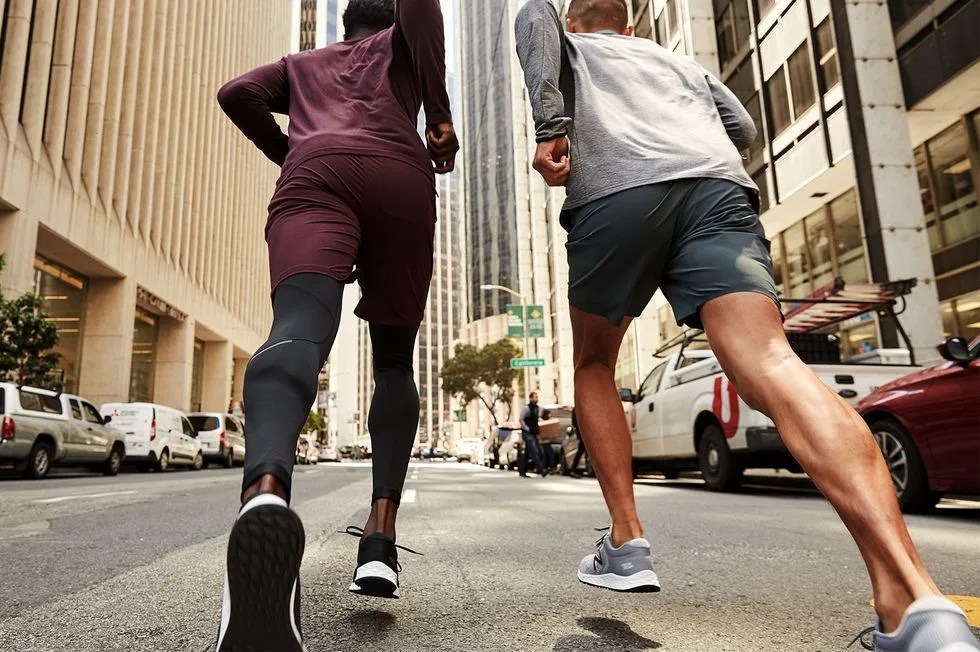 two people running through a city