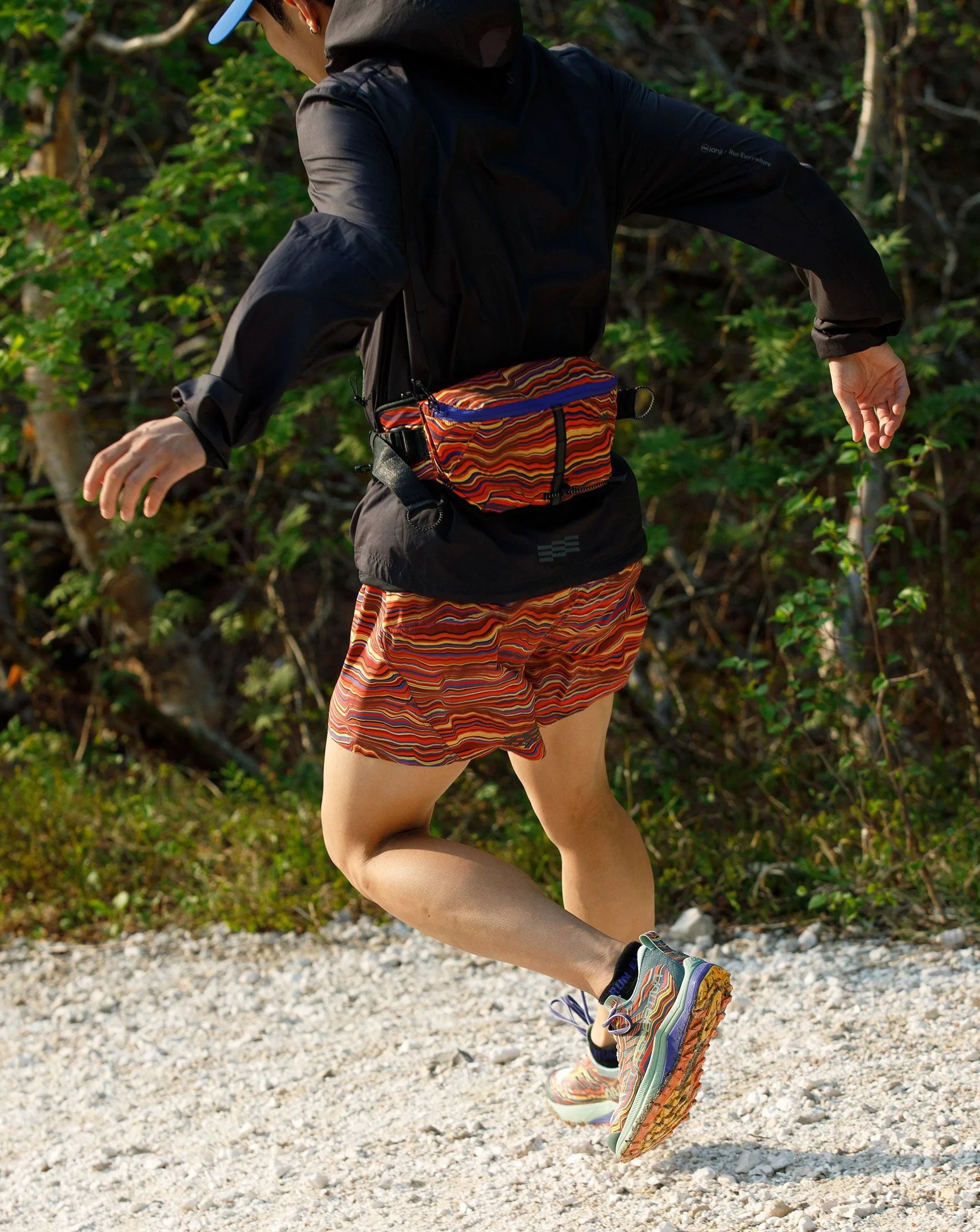 man running wearing janji la sportiva collection