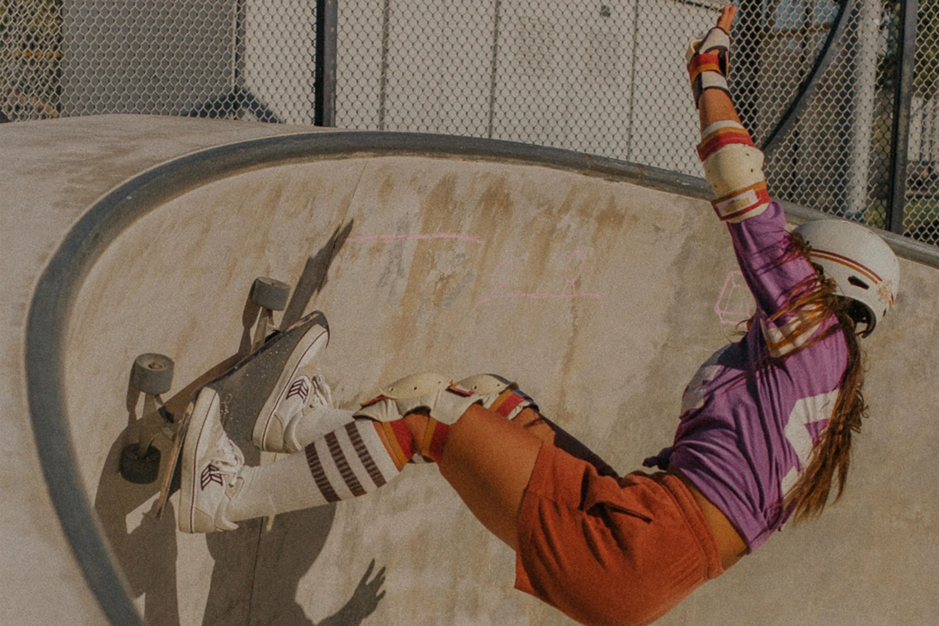 a woman skateboarding in a skatepark