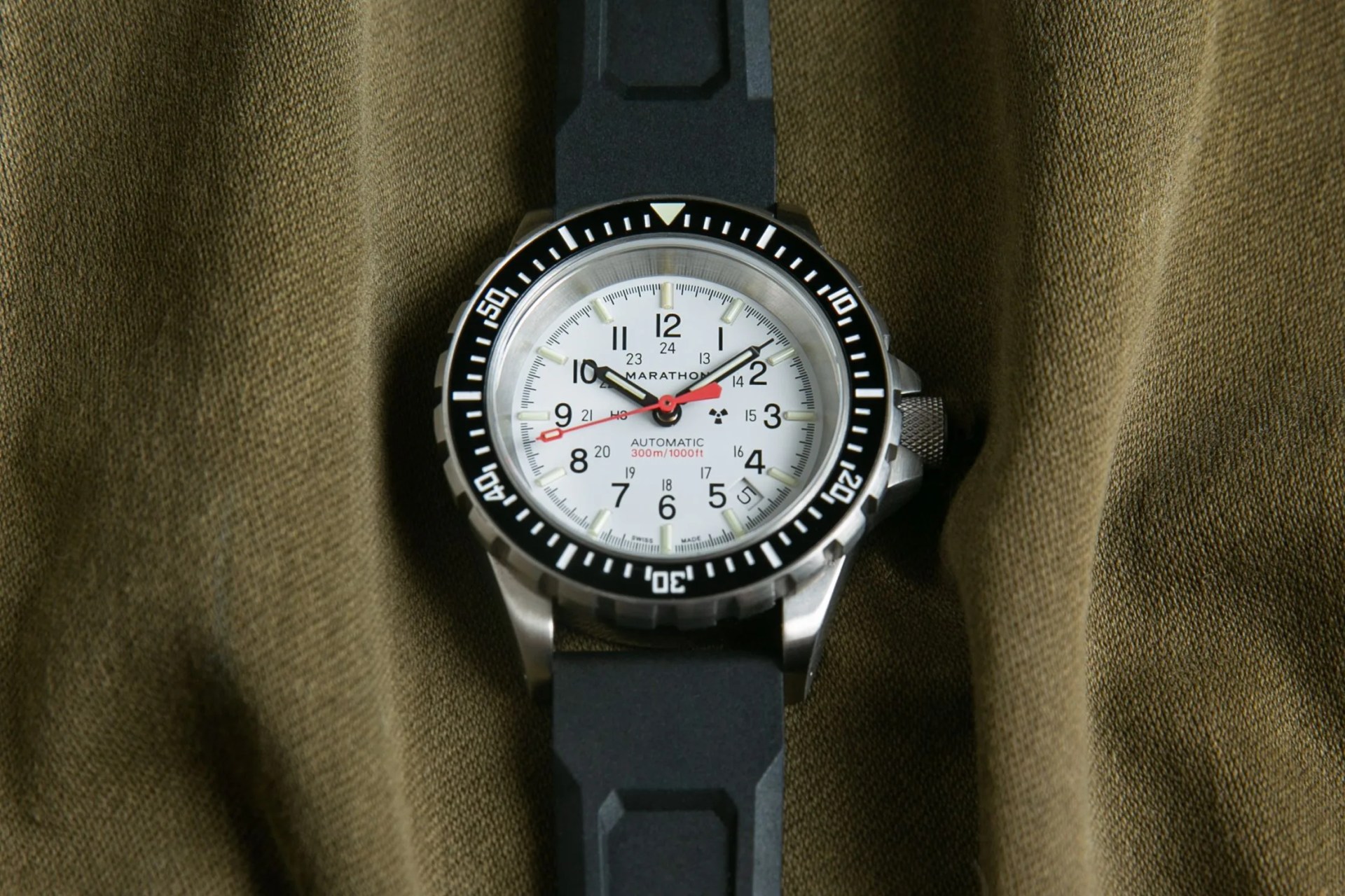 white dial military watch on green fabric