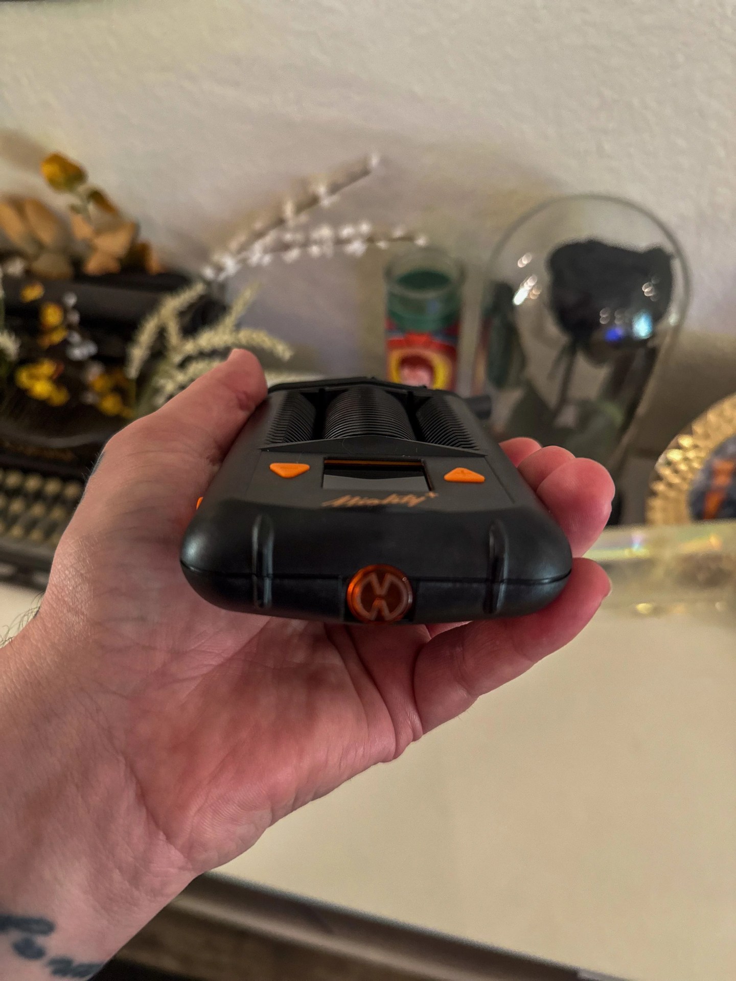 a person holding a mighty plus weed vape