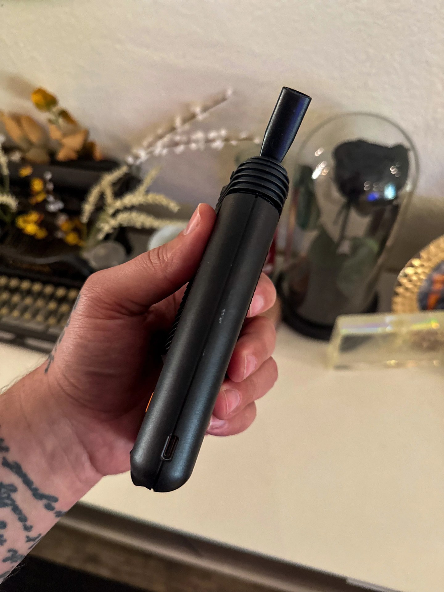 a person holding a mighty plus weed vape