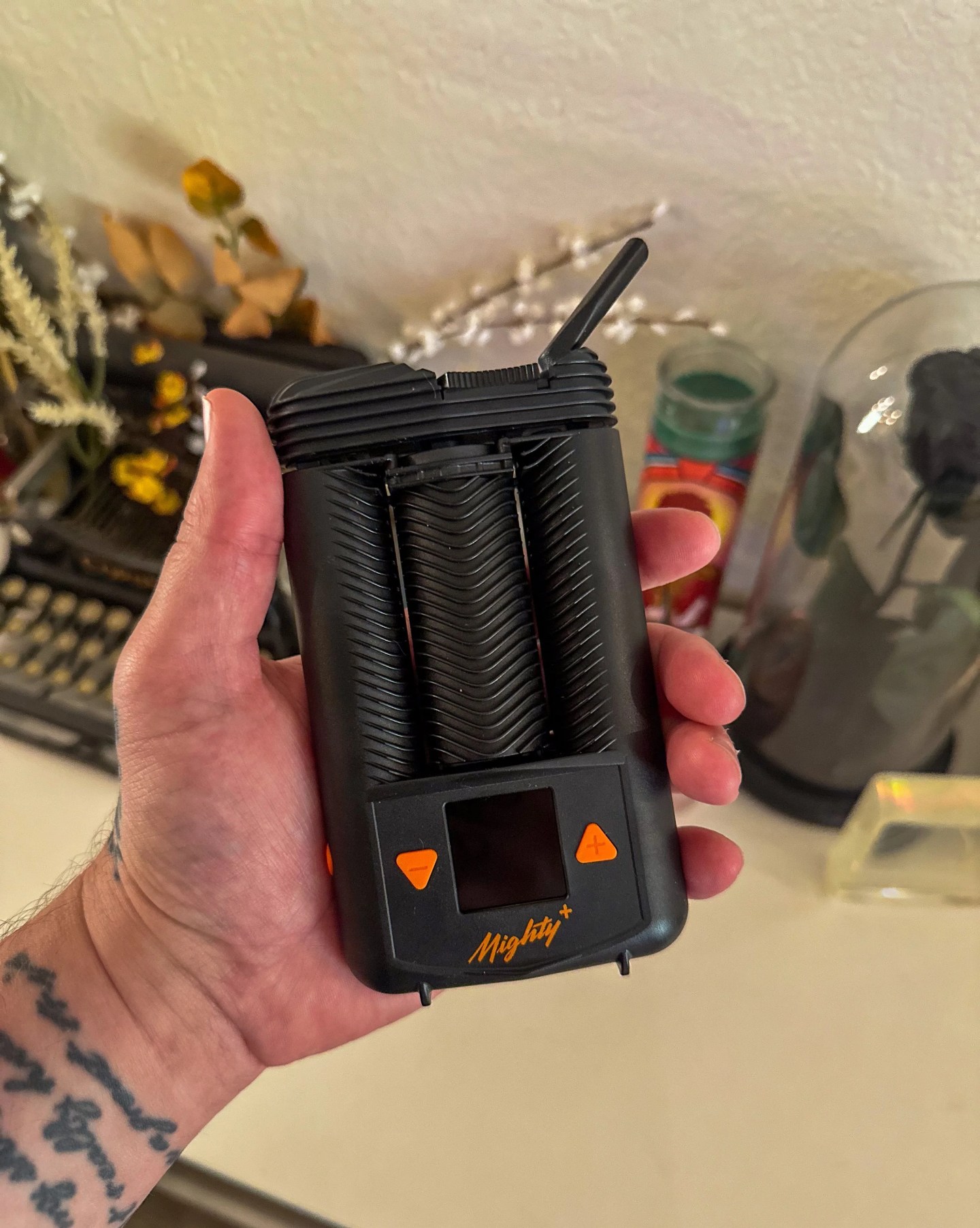 a person holding a mighty plus weed vape