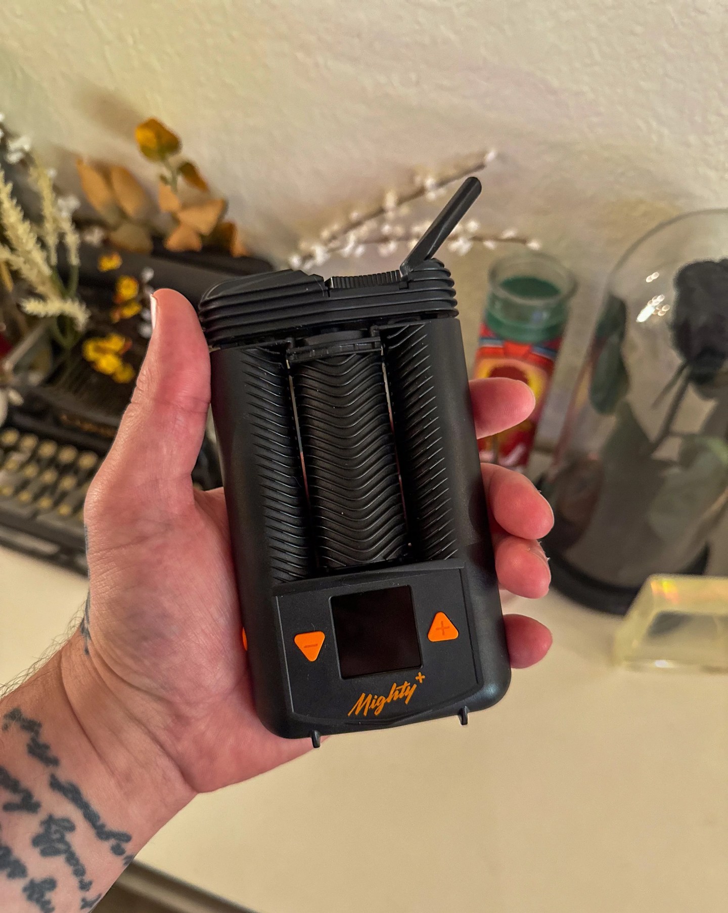 a person holding a mighty plus weed vape