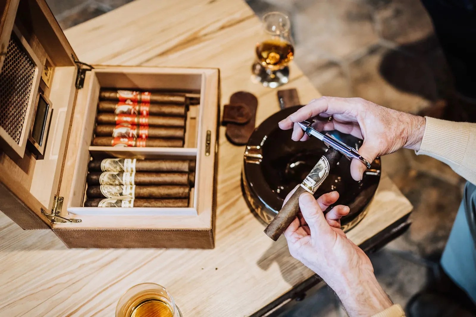 man cutting cigar