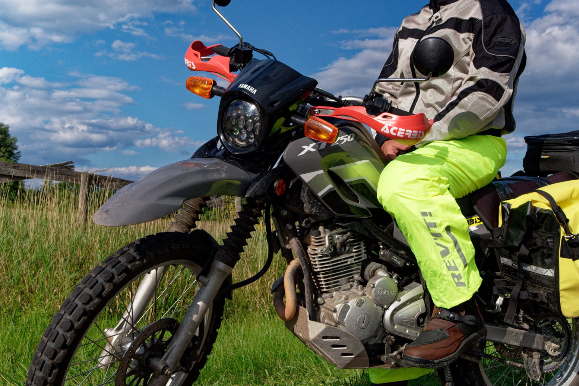 a man sitting on a motorcycle wearing motorcycle pants