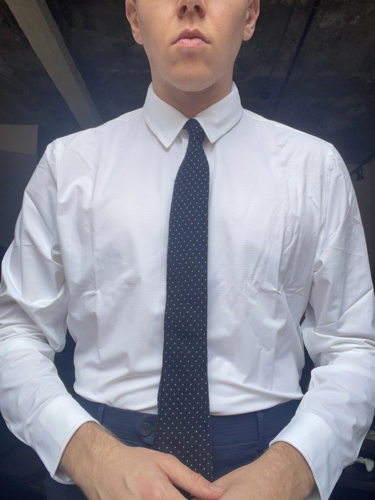 Rhone commuter dress shirt on white male wearing a tie