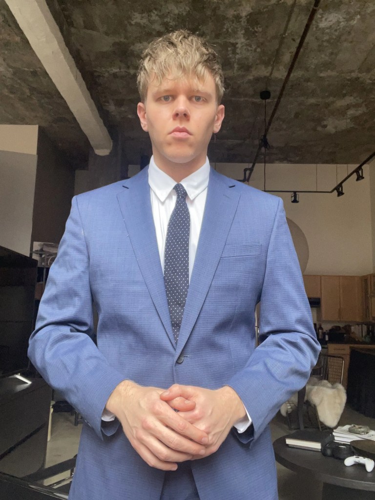 Rhone commuter dress shirt on white male wearing a blazer and tie