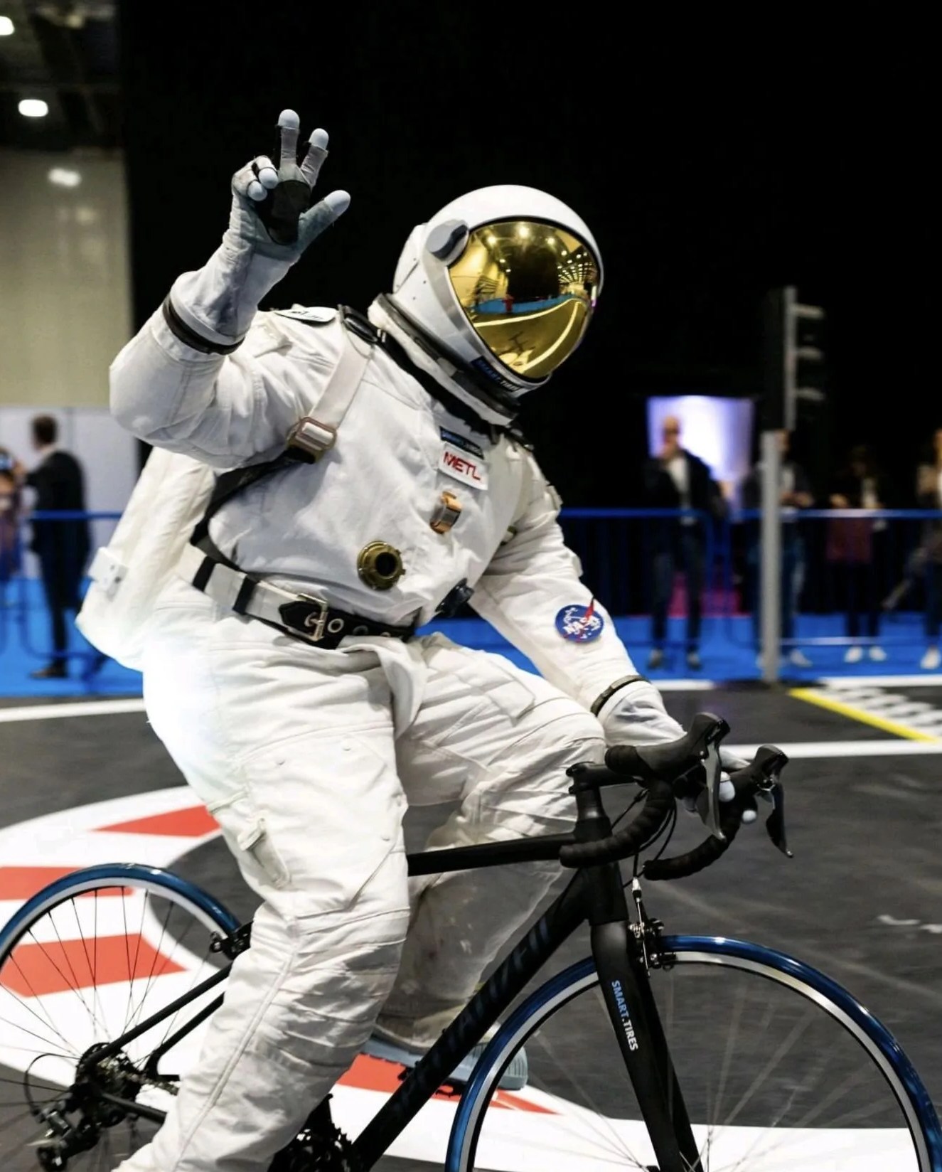 man wearing space suit riding bike using the smart tire company tires