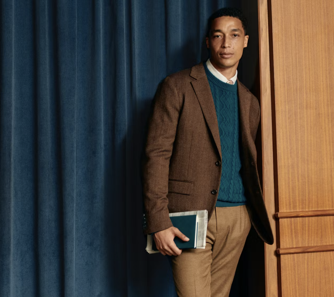 model in suit holding book