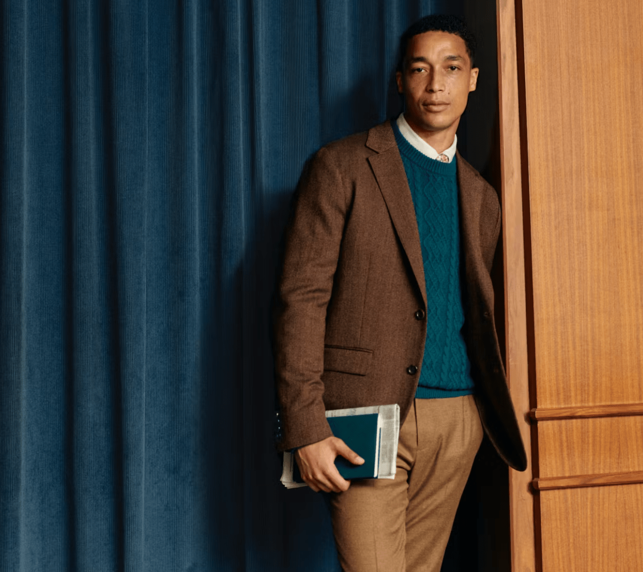 model in suit holding book