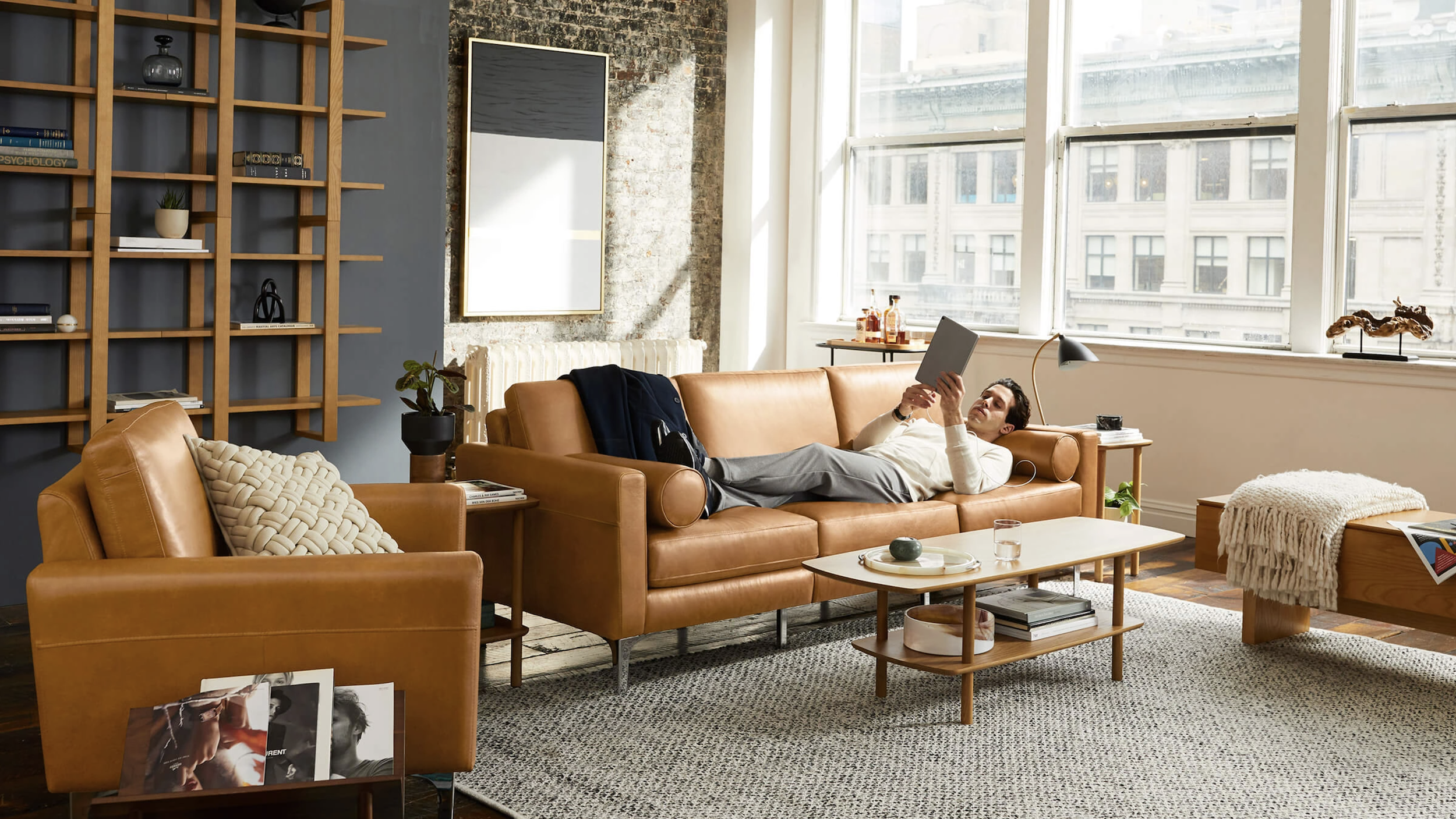 a man on a sofa reading