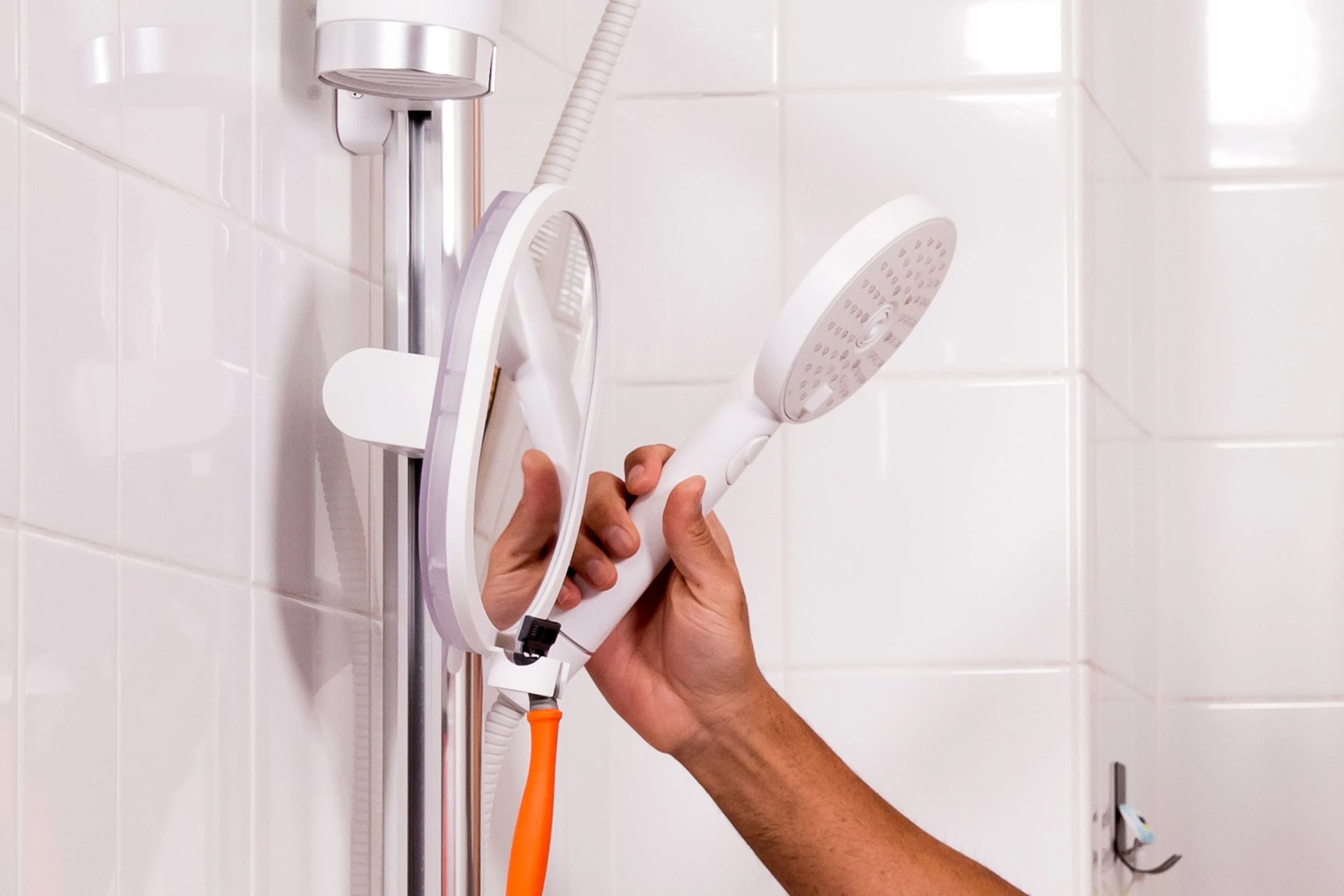 a person using a sproos shower head in a shower