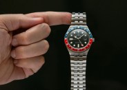 timex q gmt watch with red and blue bezel and steel bracelet