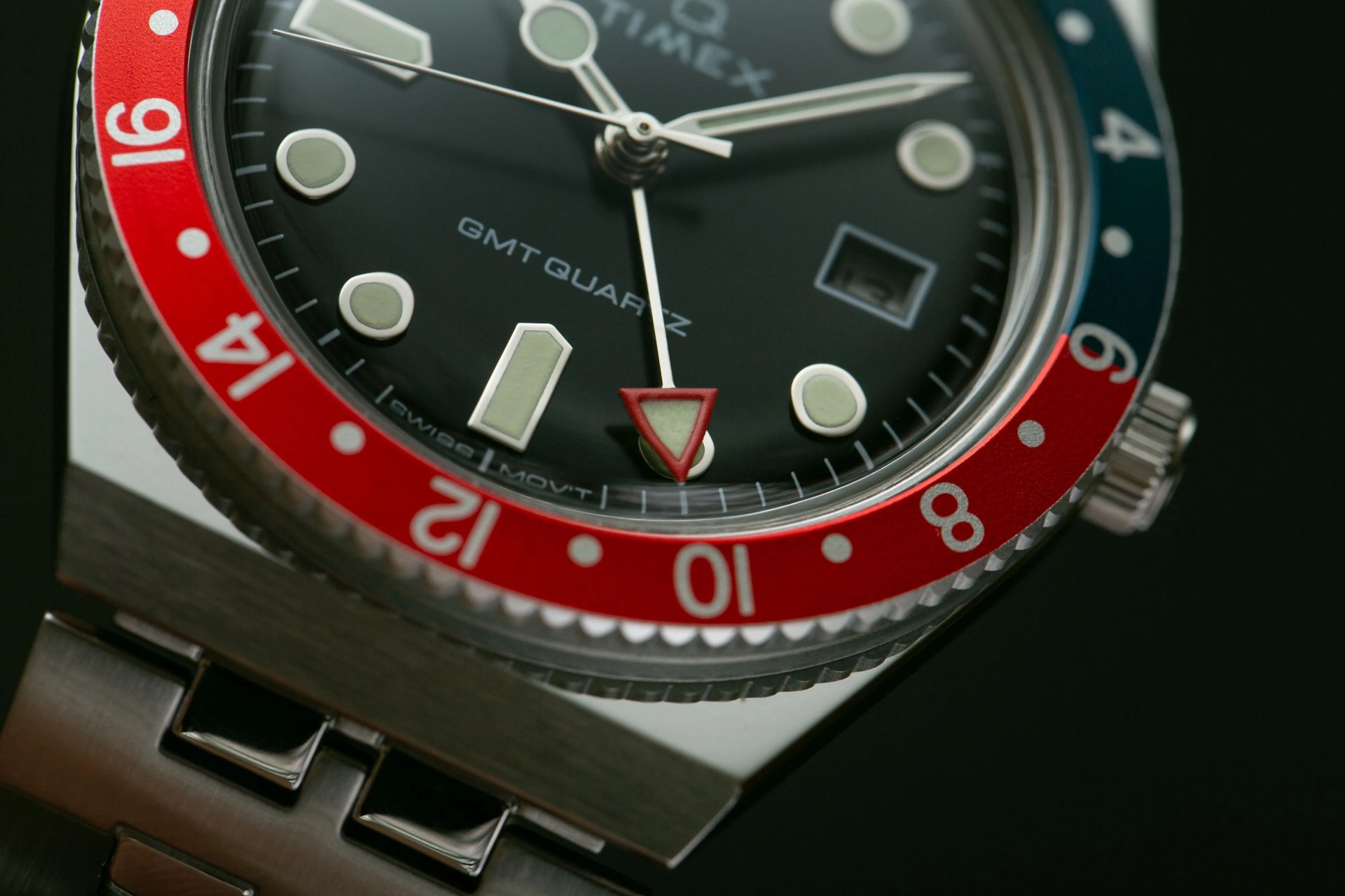 timex q gmt watch with red and blue bezel and steel bracelet