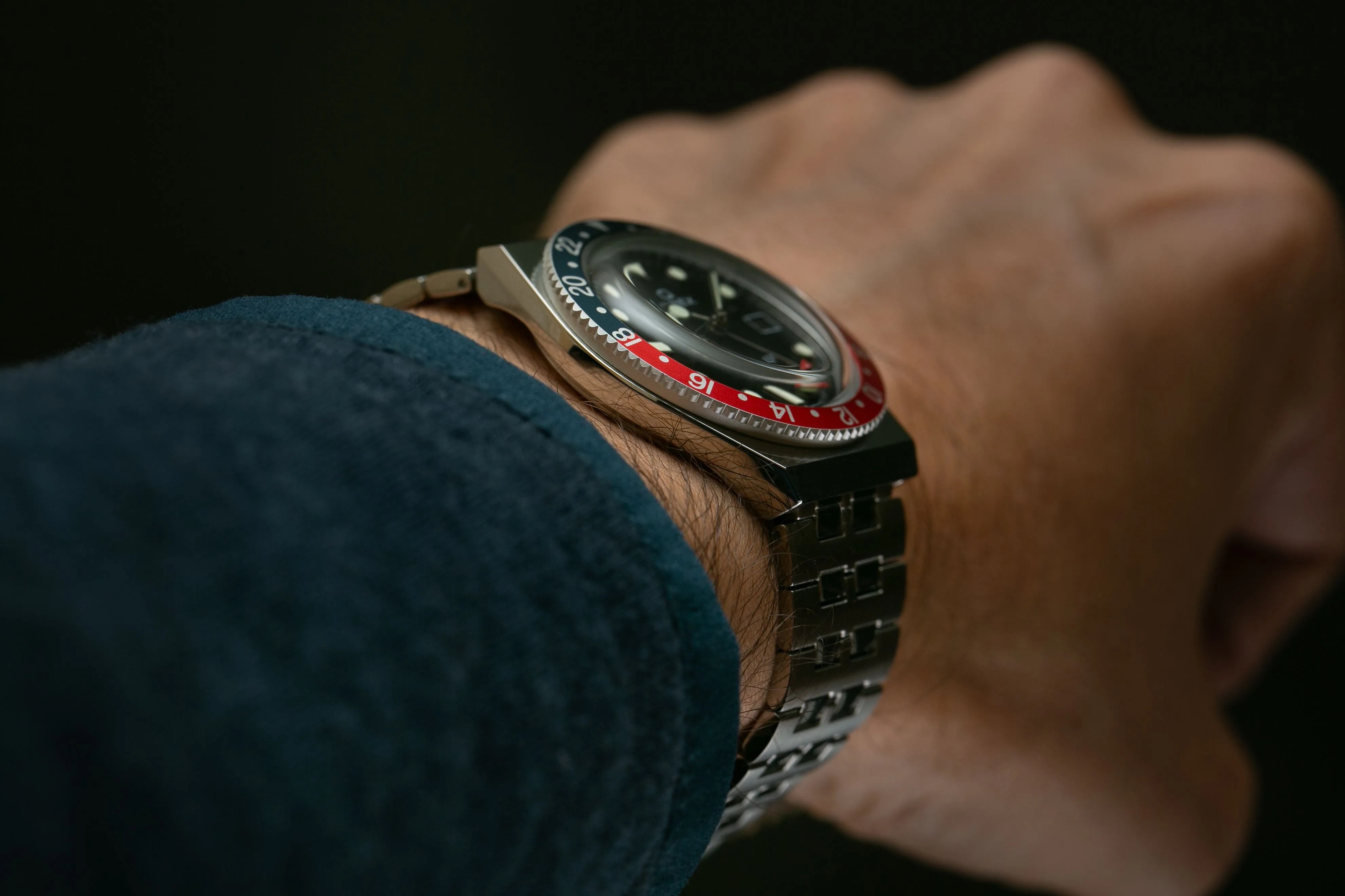 timex q gmt watch with red and blue bezel and steel bracelet