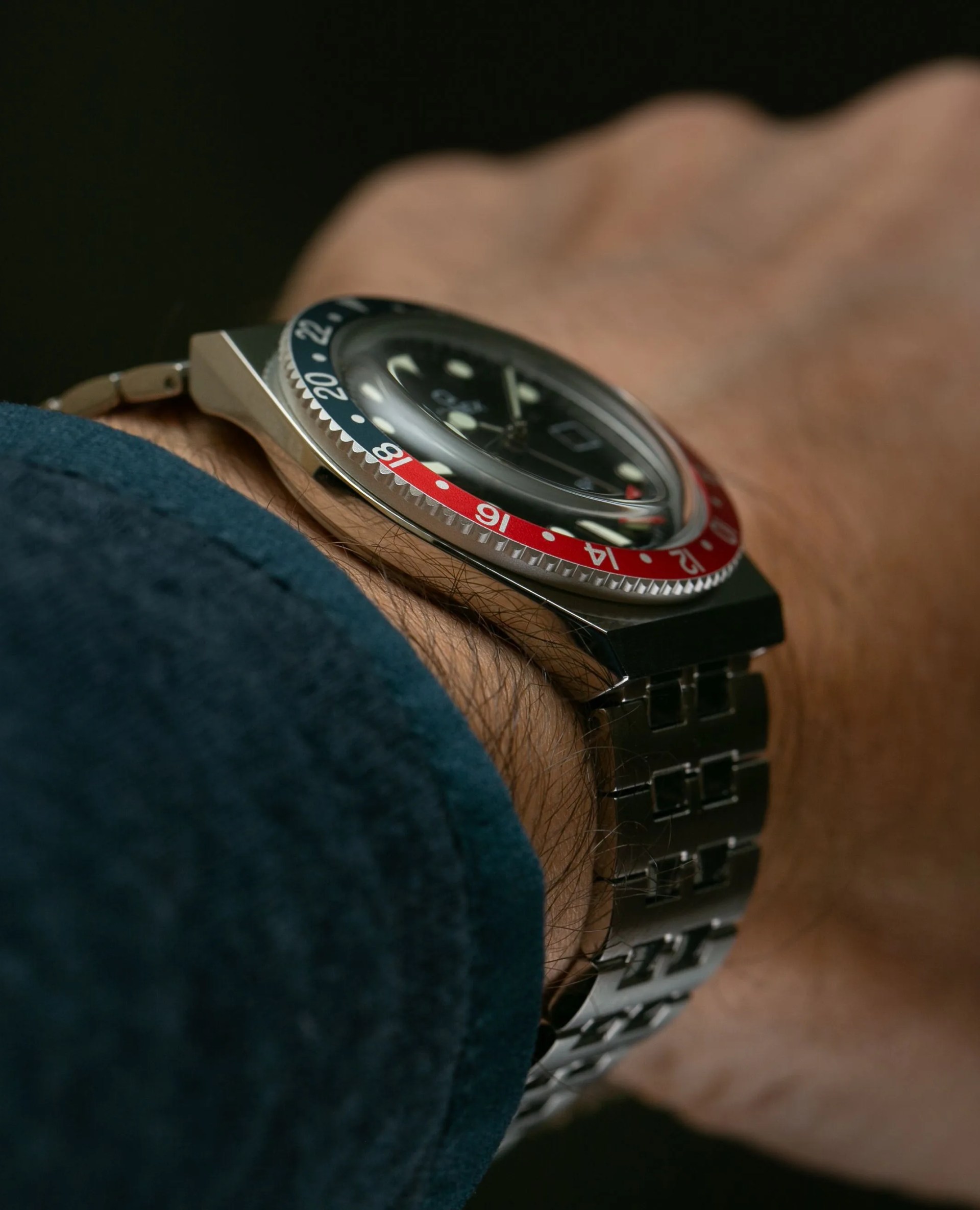 timex q gmt watch with red and blue bezel and steel bracelet