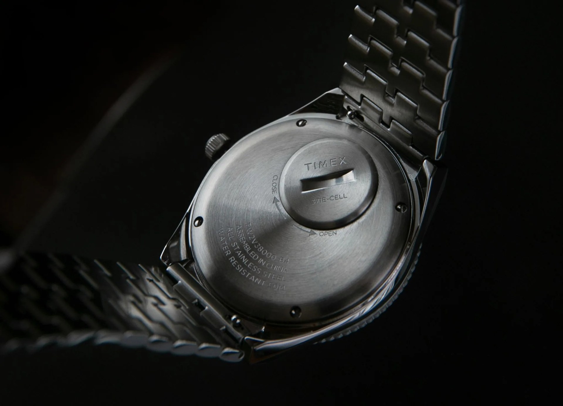 timex q gmt watch with red and blue bezel and steel bracelet