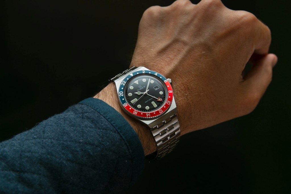 timex q gmt watch with red and blue bezel and steel bracelet