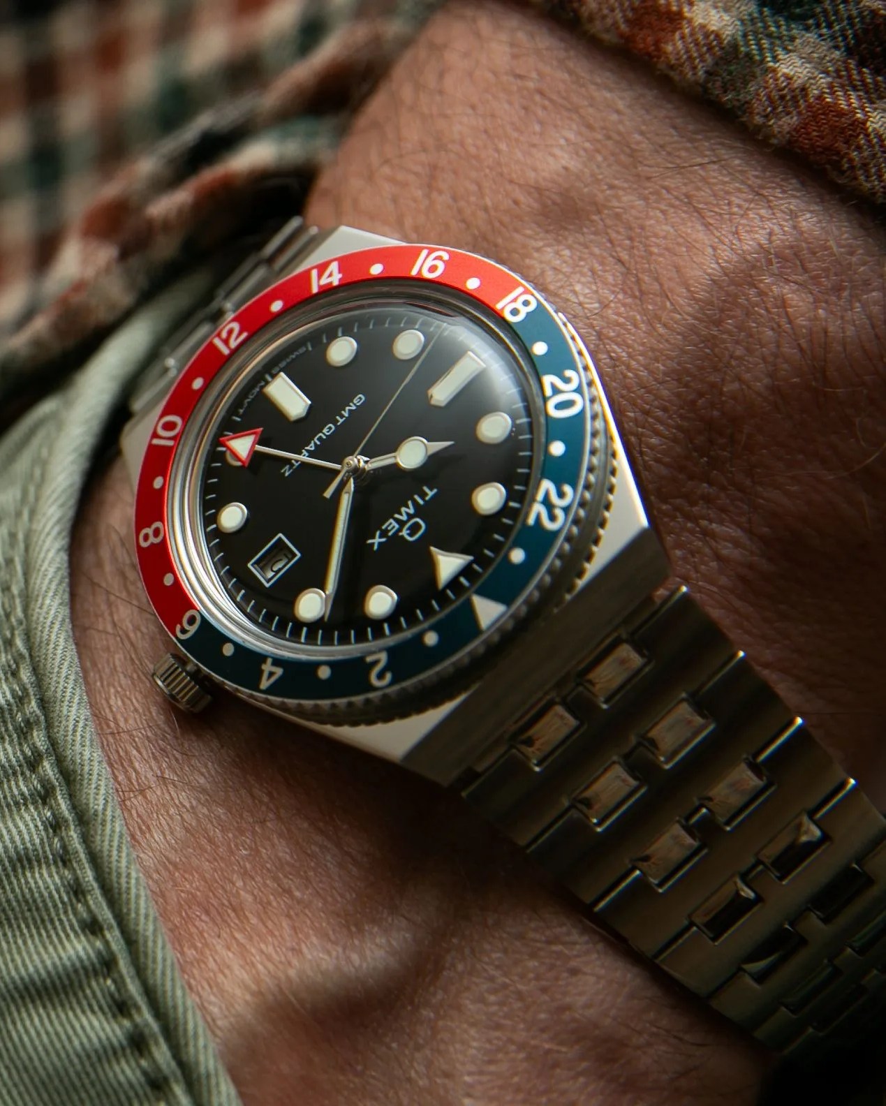 timex q gmt watch with red and blue bezel and steel bracelet