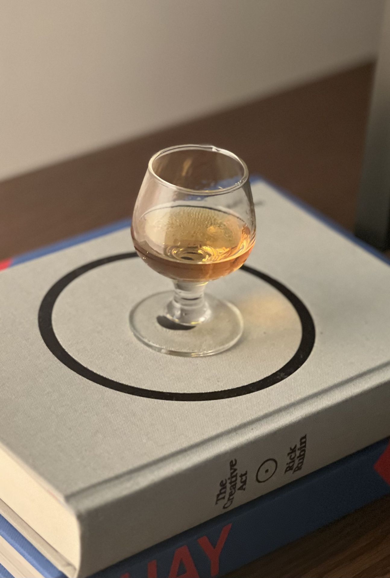 glass of whiskey on books