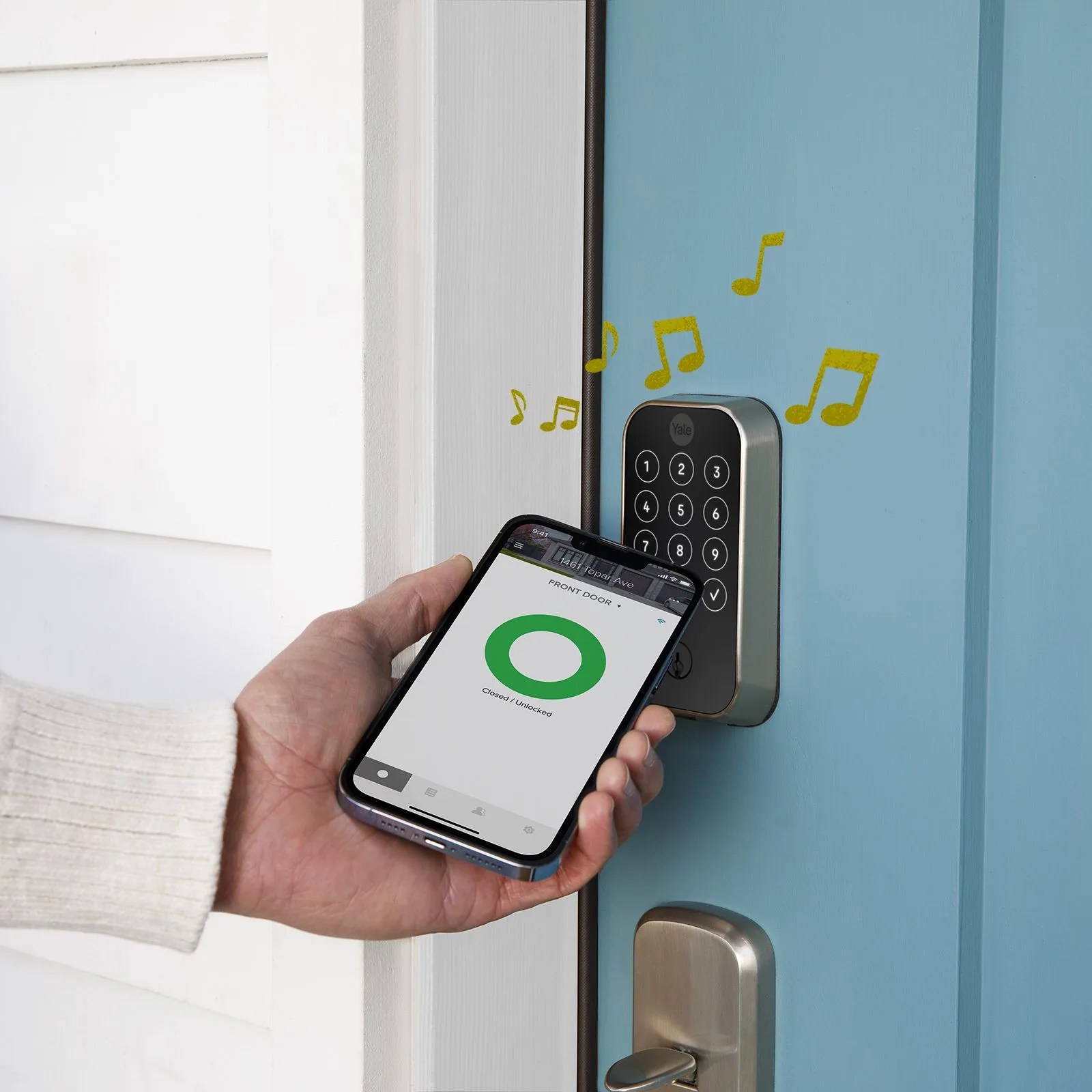 a person opening a door lock with an app on a phone