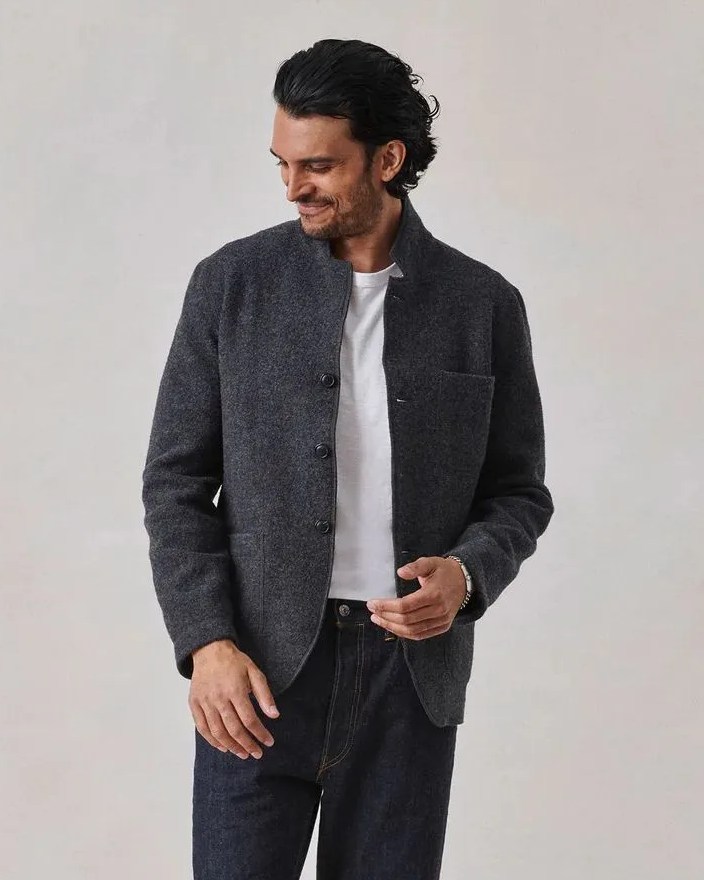 a man wearing buck mason felted chore coat