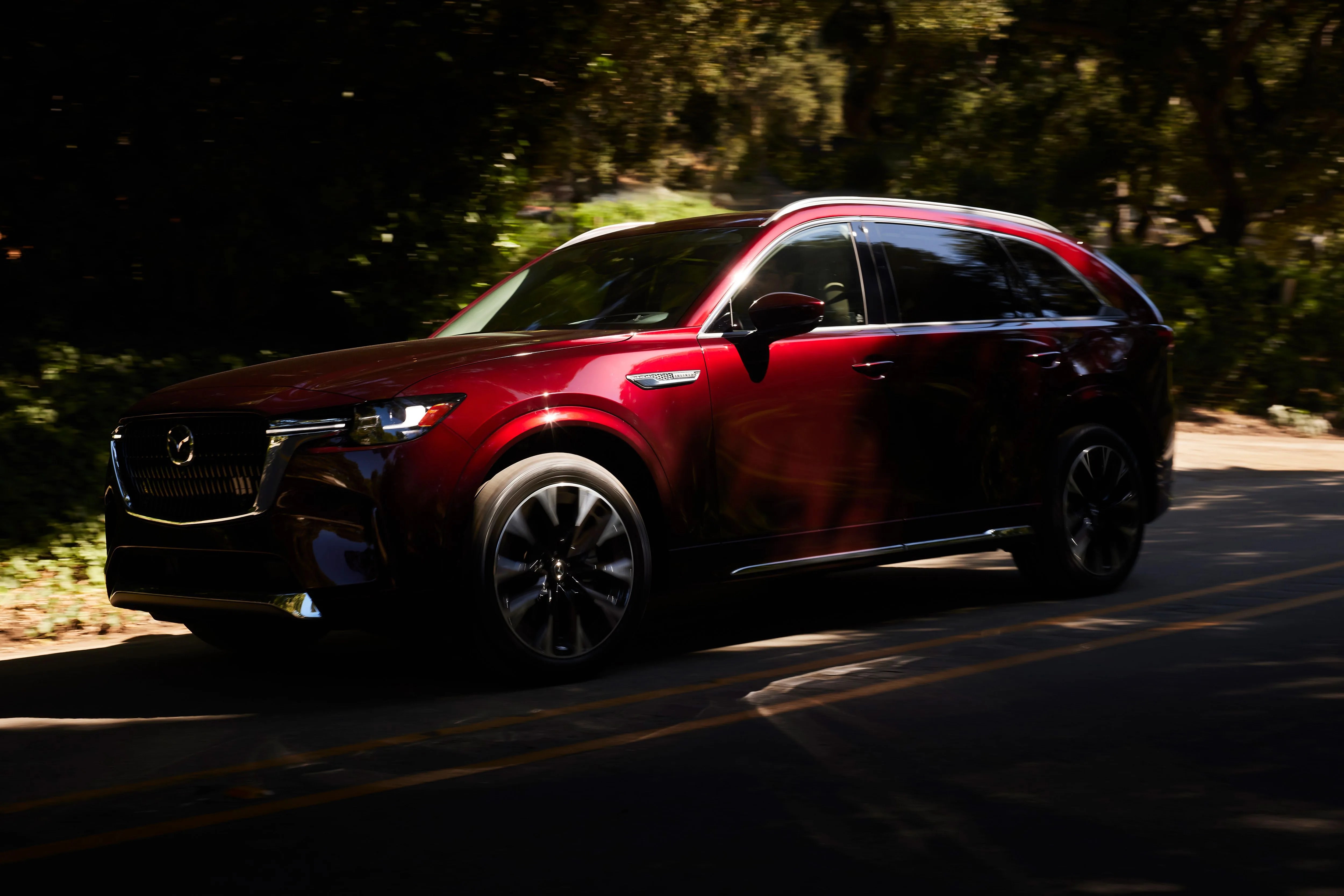 a red car driving on a road