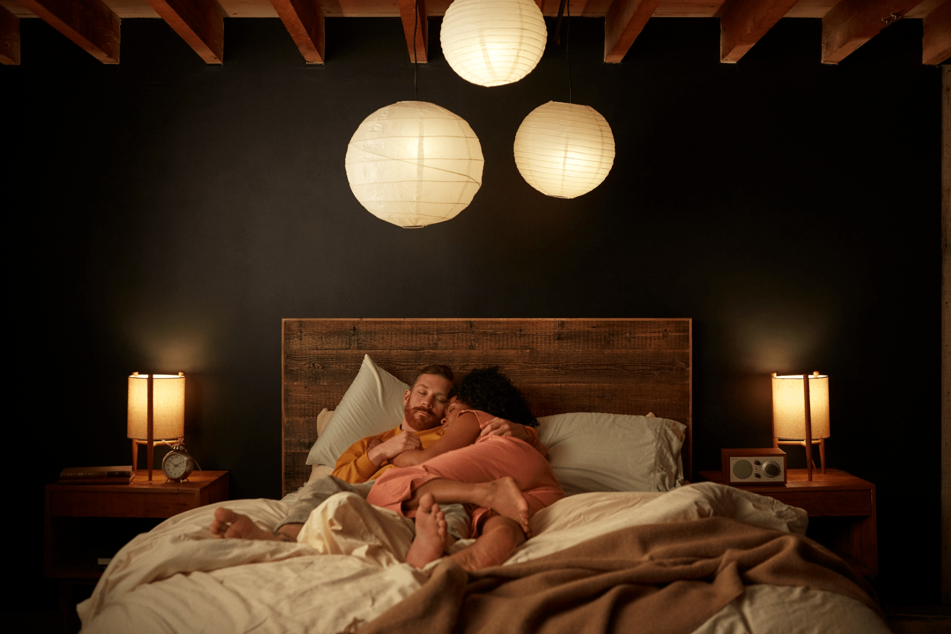 a couple of people lay on a bed