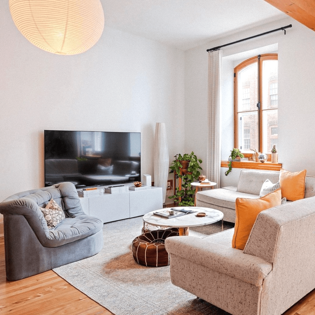 a living room with a tv and couches