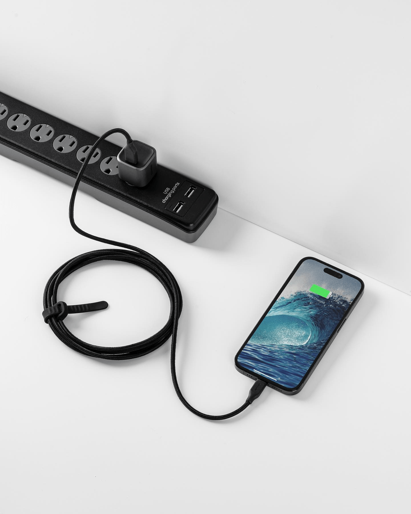 a black corded phone with a charger attached to it