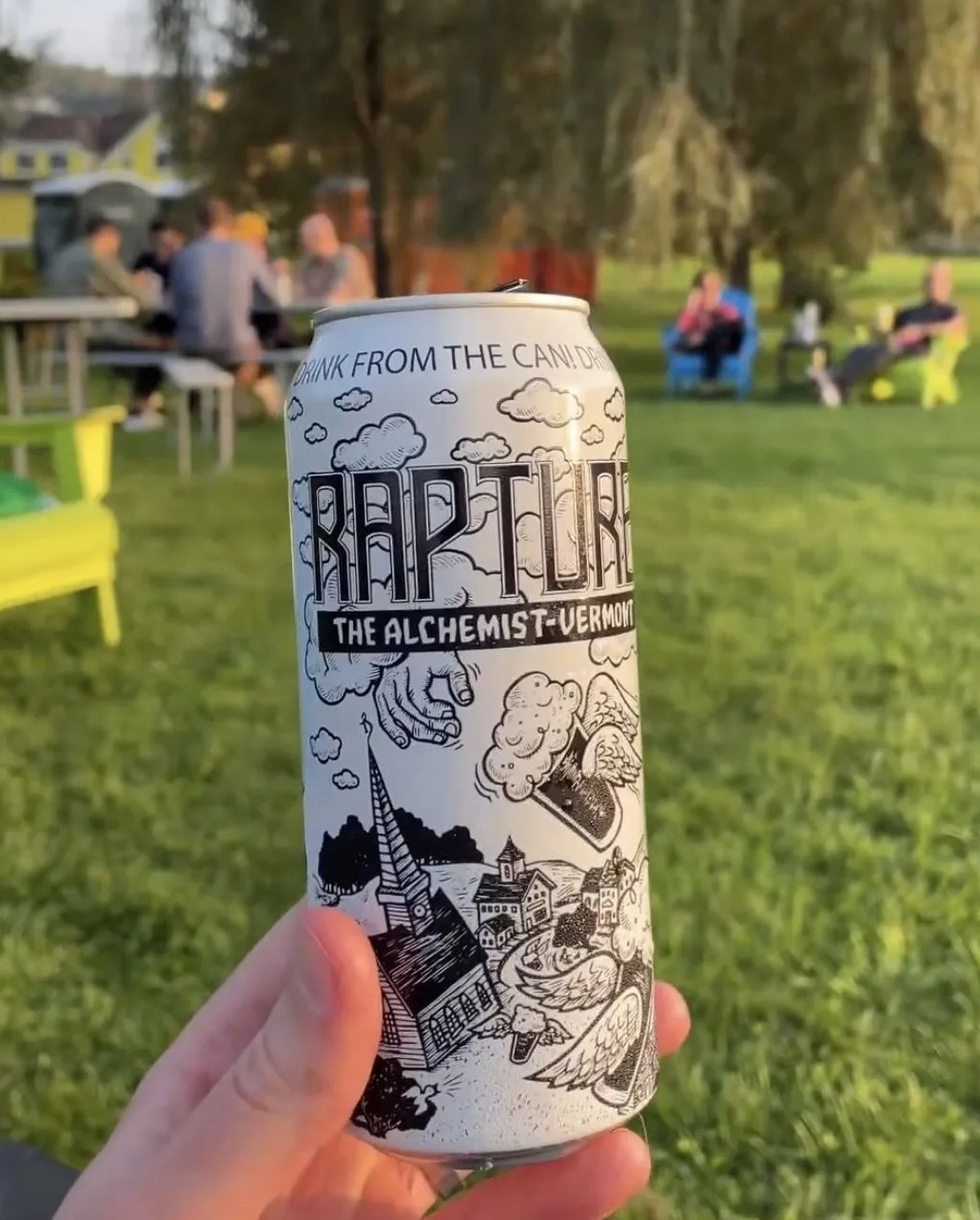 a hand holding a can of beer