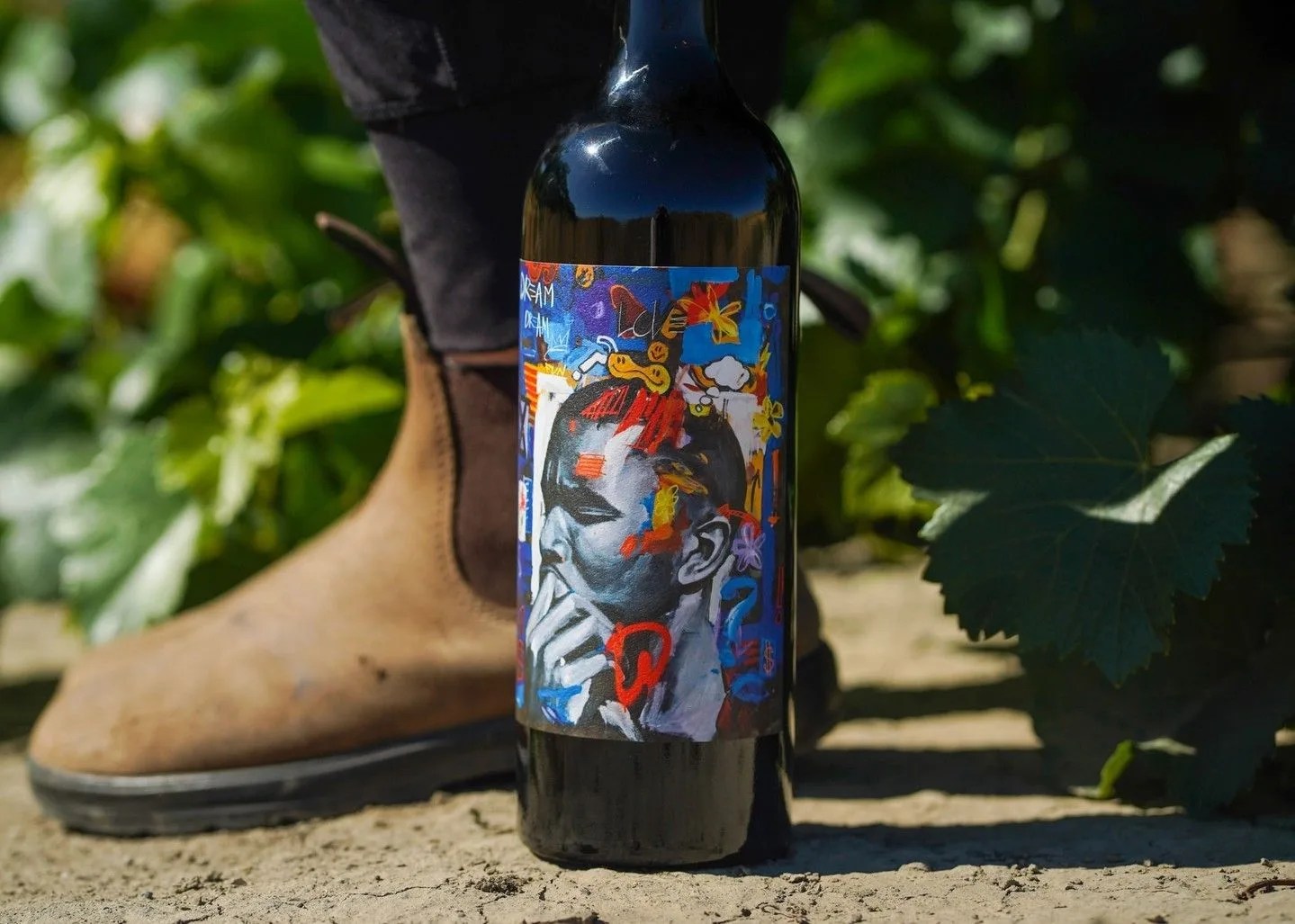 blundstone boot next to wine bottle