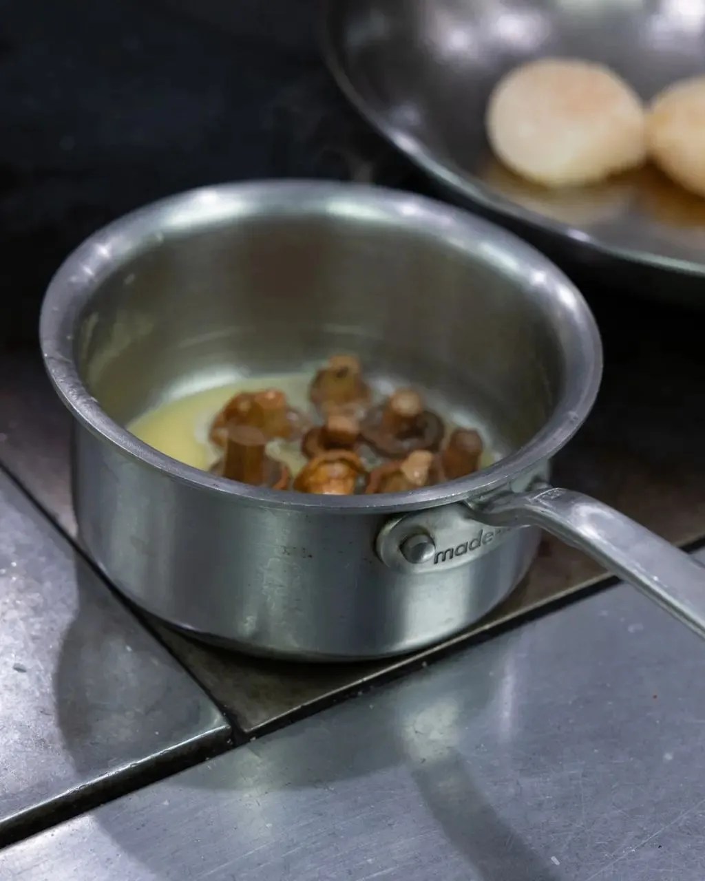 made in stainless clad butter warmer with butter and mushrooms in pot
