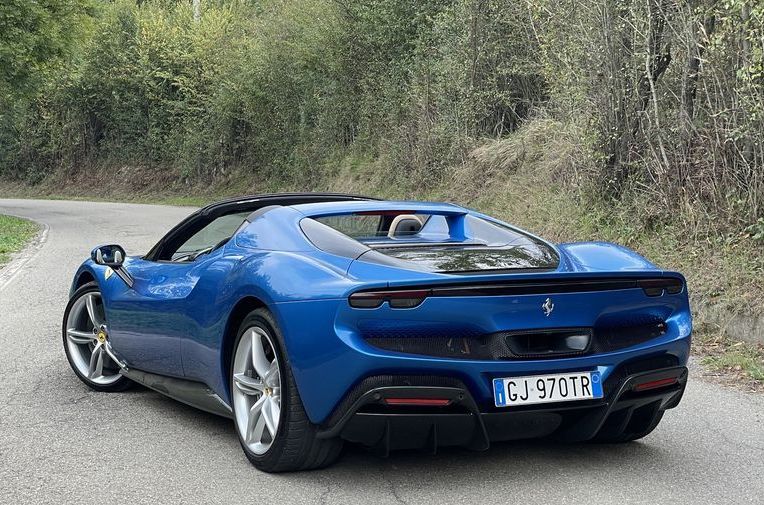 a blue sports car on a road