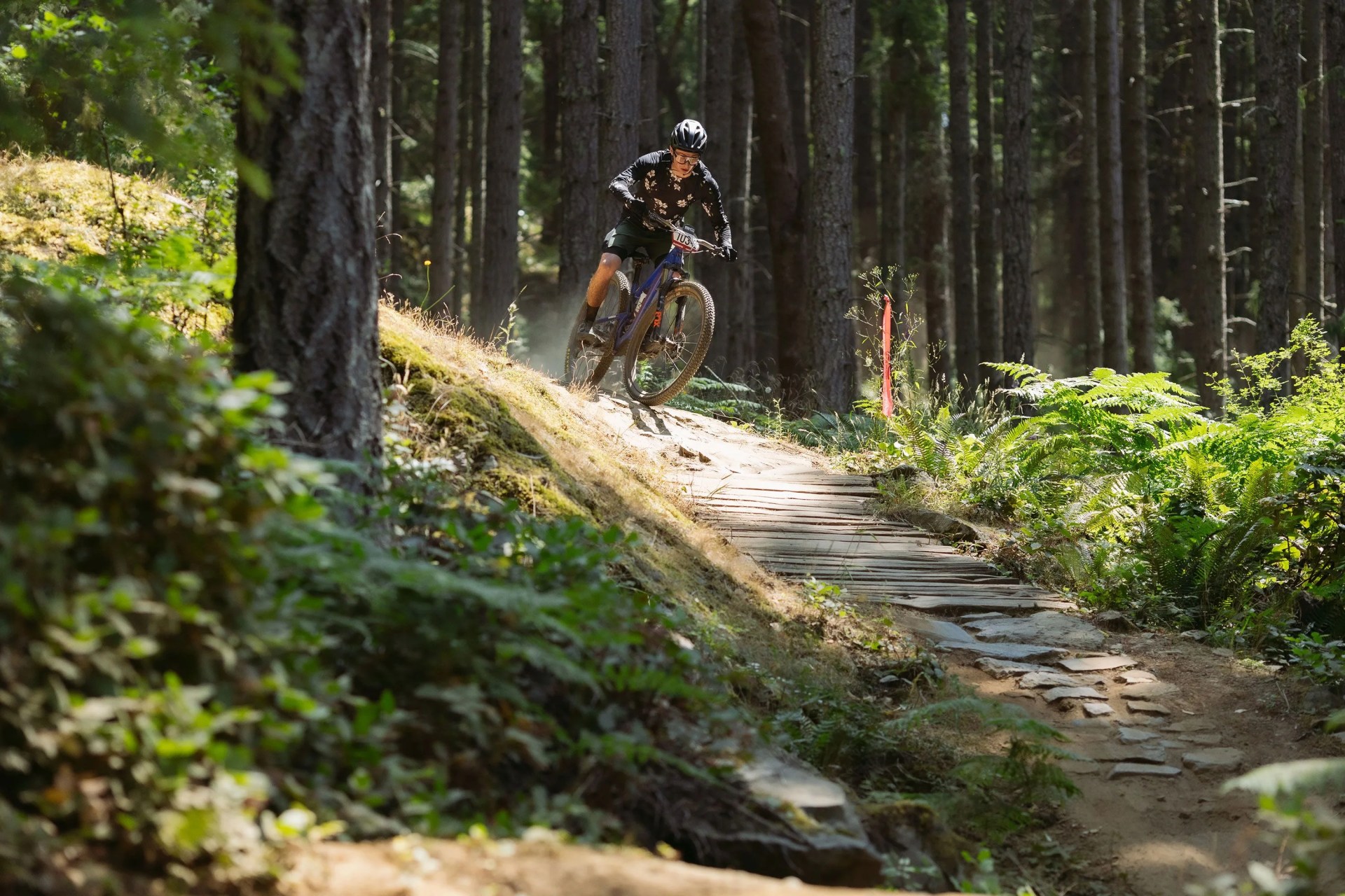 men riding bikes wearing fox facing cross frame pro helmet and flexor ascent clothing