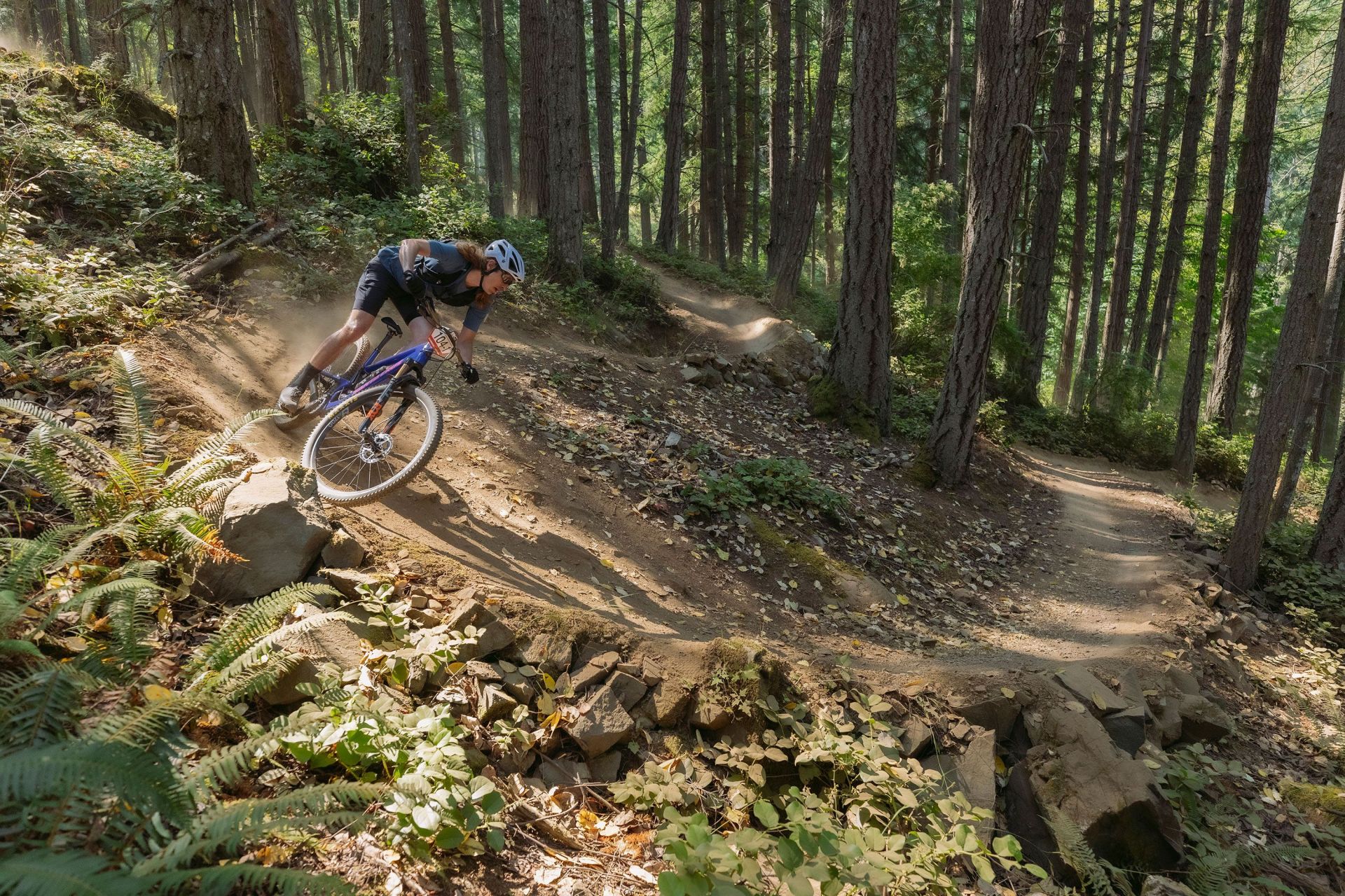 men riding bikes wearing fox facing cross frame pro helmet and flexor ascent clothing