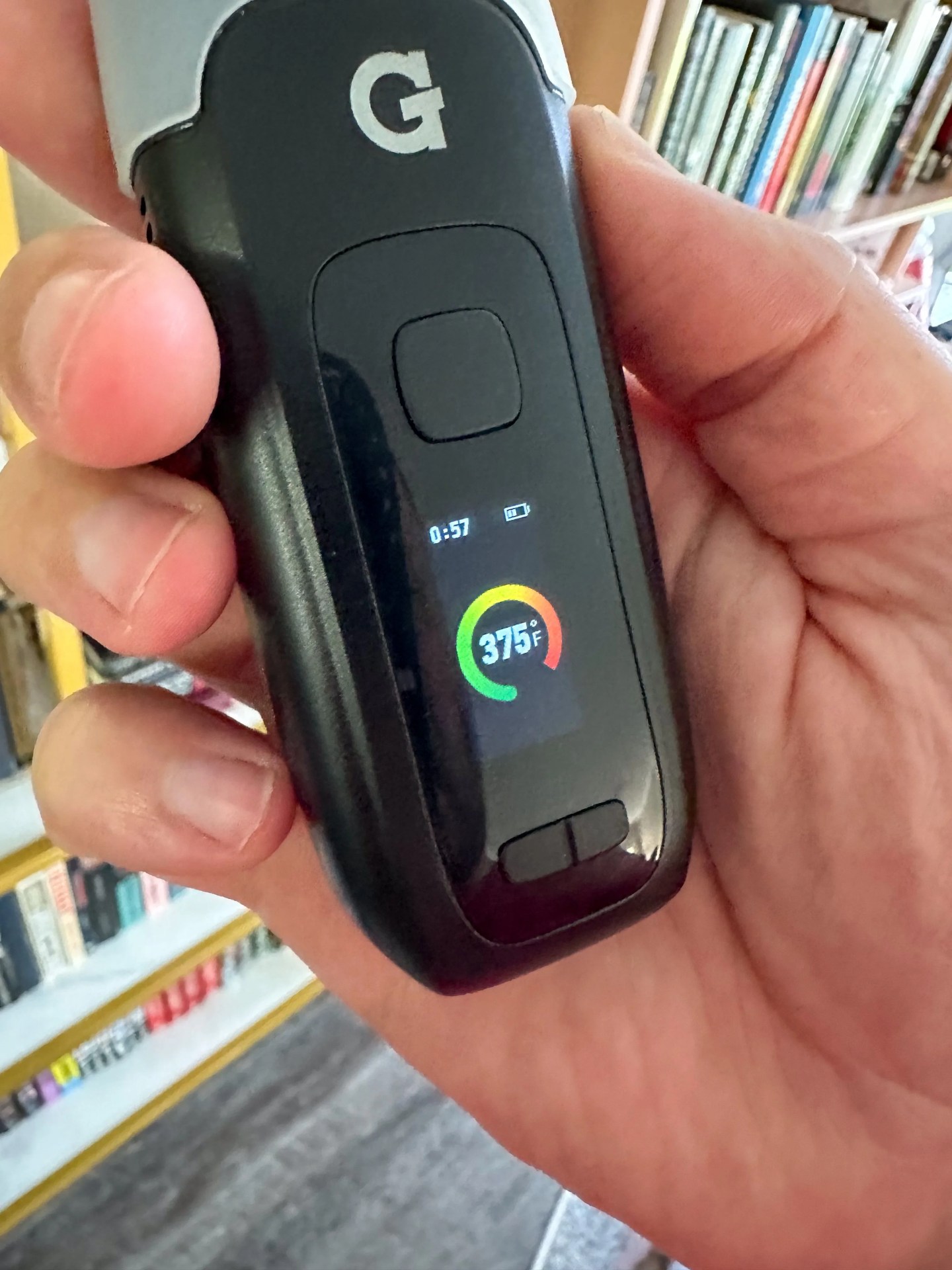 a person holding a g pen dash plus vape