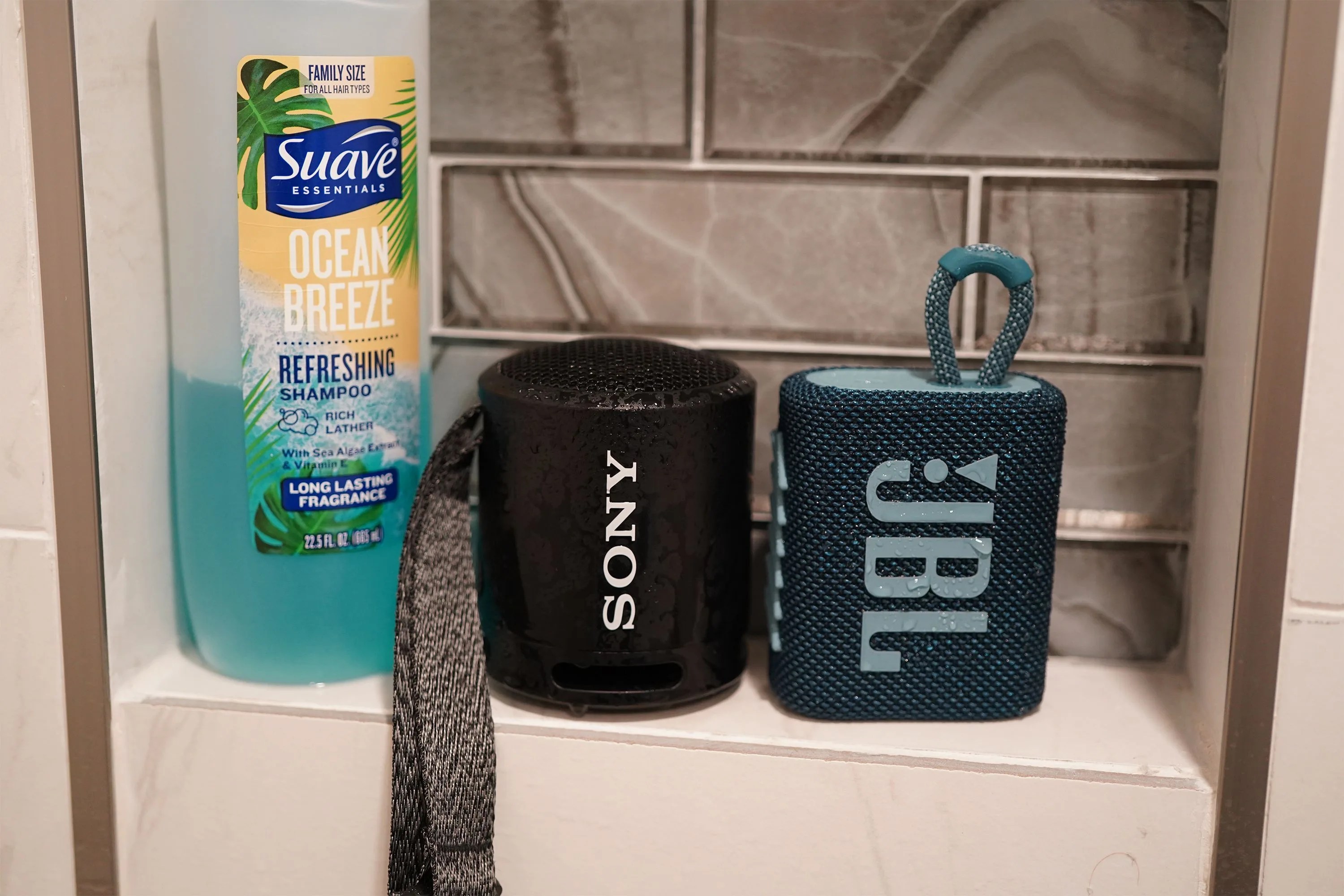 two bluetooth speakers in a shower
