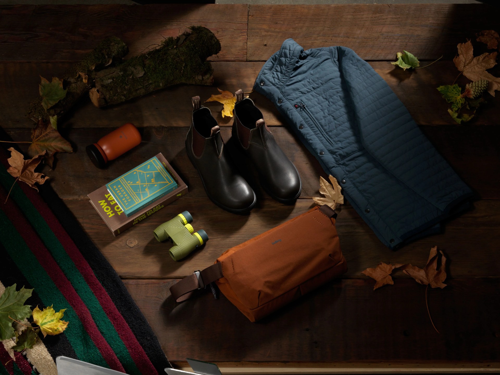 blundstone boots, jacket, waist pack, binoculars and fall leaves