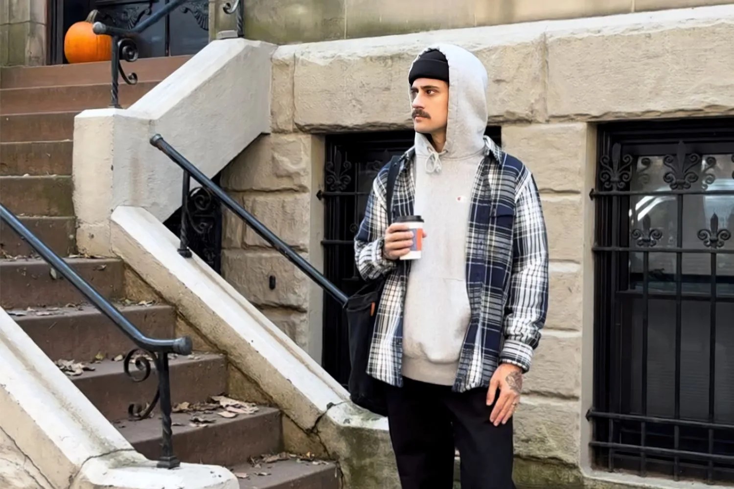 man wearing blanket shirt over hoodie