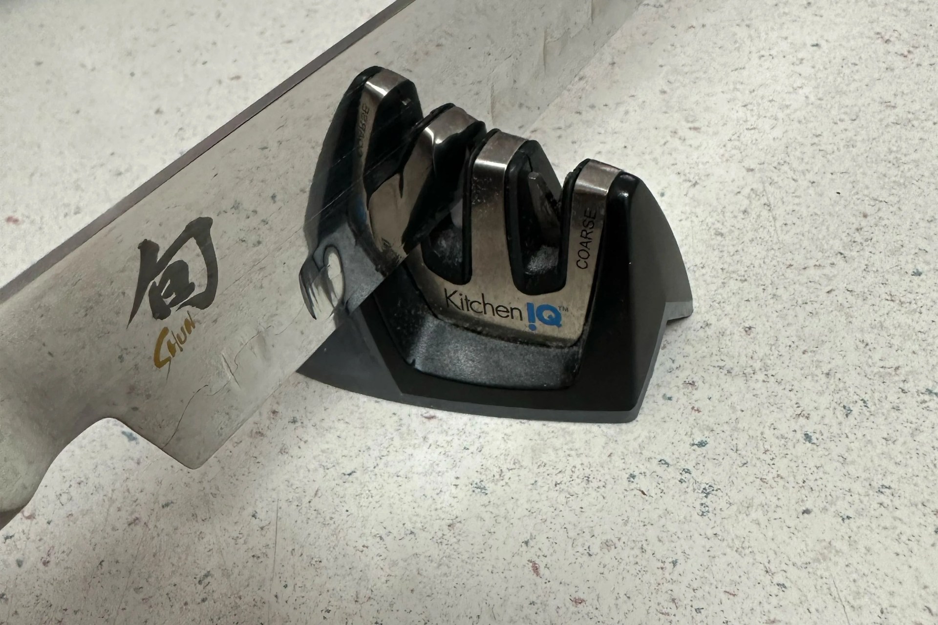 kitcheniq knife sharpener being used on a counter