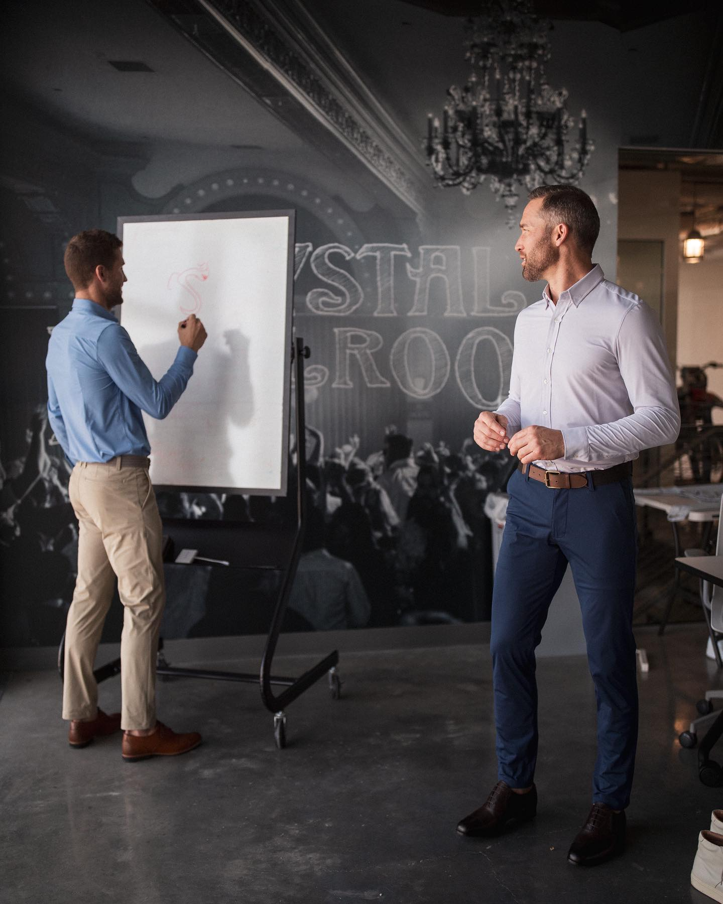 men standing in front of a whiteboard