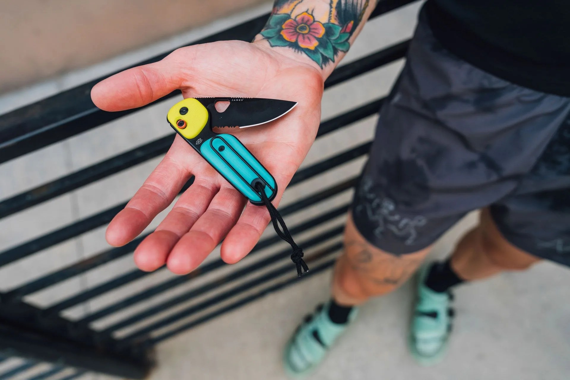 a person holding a small black and yellow object with a face on it