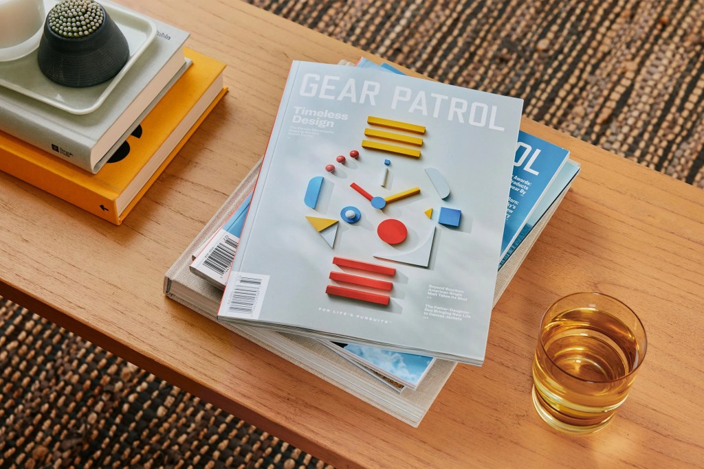 a stack of gear patrol magazines on a table