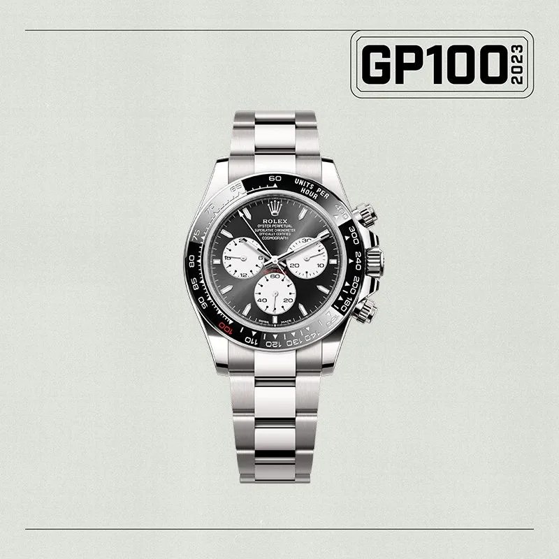 a silver watch with a black face
