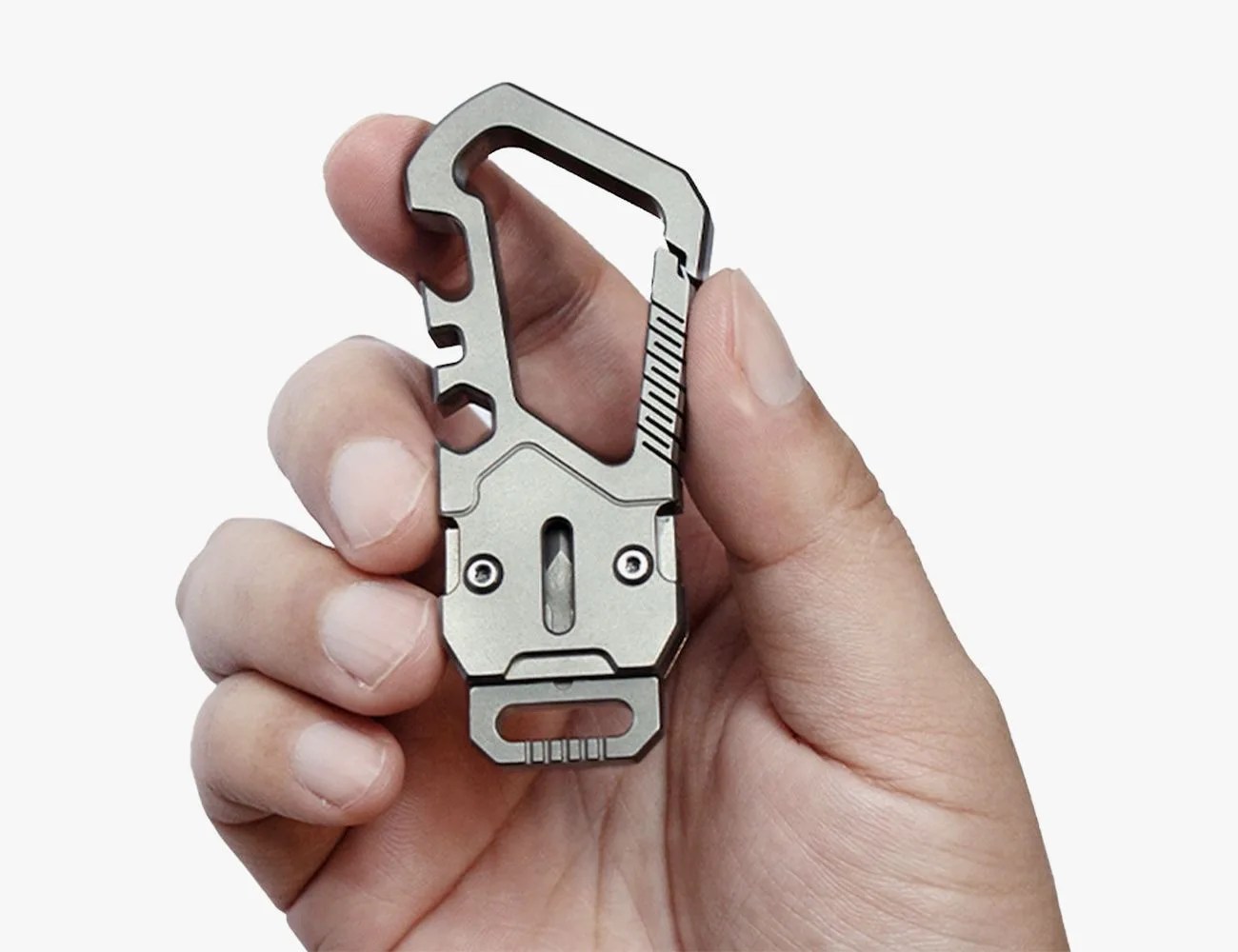 a hand holding a small silver device